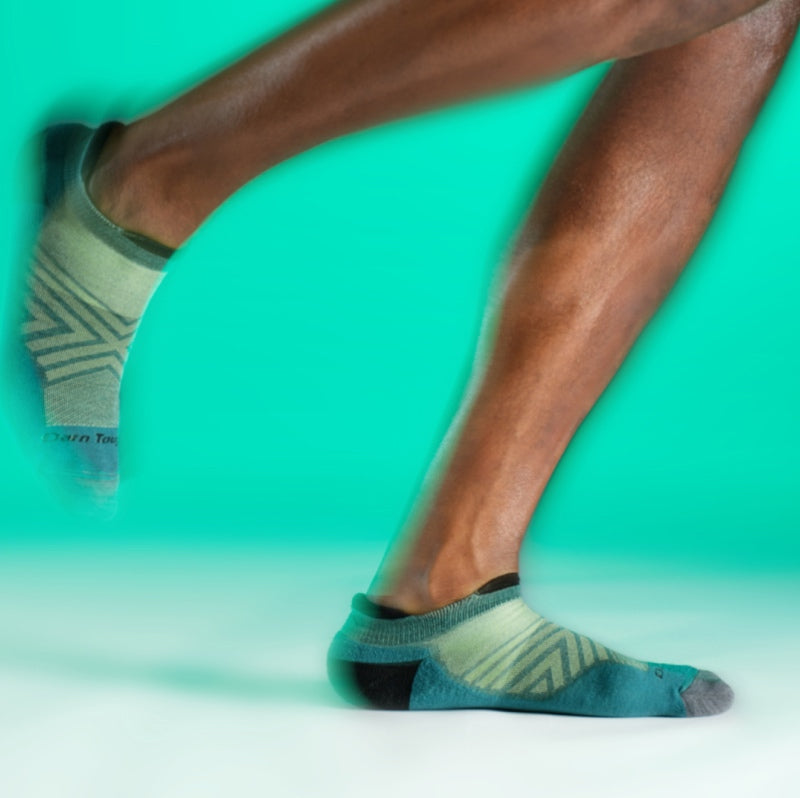 Feet wearing the run no show tab sock and taking a running stride