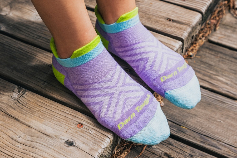 Feet wearing the women's run no show tab sock (no cushion) in lavender