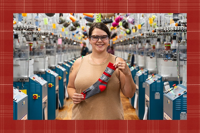 Felicia at the Mill holding up the Elsa sock in gray and red