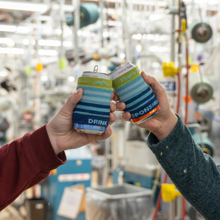 two models holding cans with the gatewood can sleeve on them 