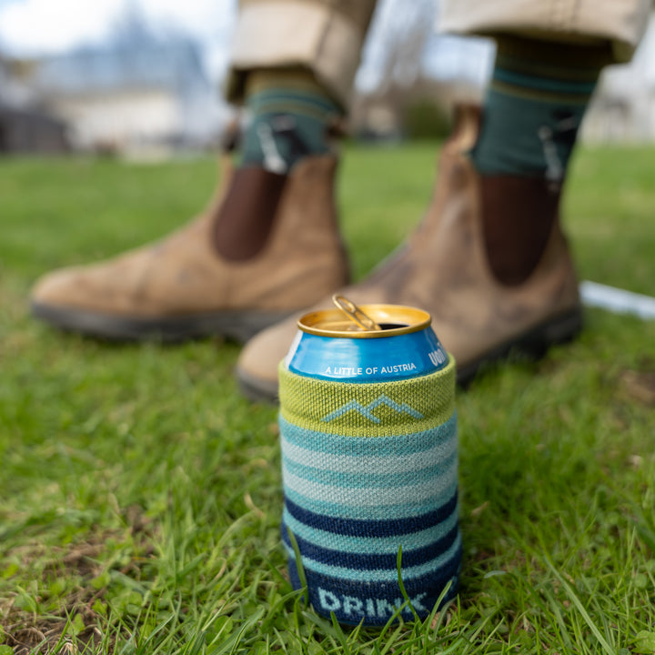 close up of can sleeve on a can with feet in background