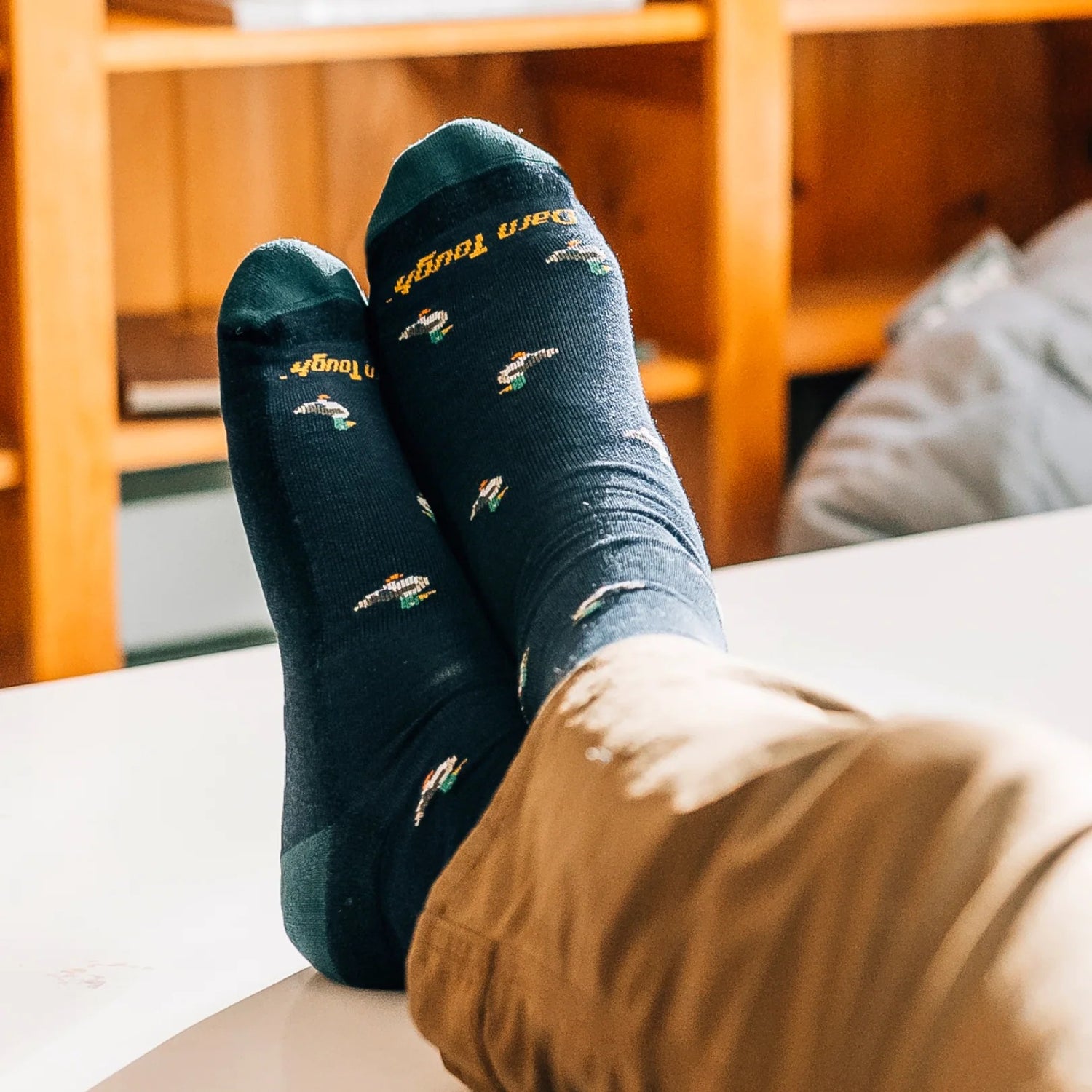 Model wearing the men's duck duck moose crew lifestyle sock