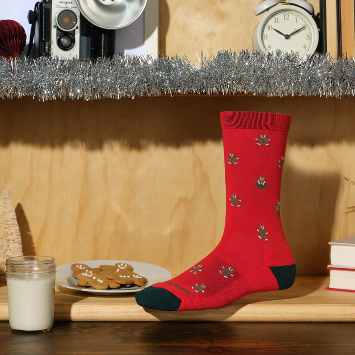 Gingerbread crew in red on a shelf with cookies and milk 