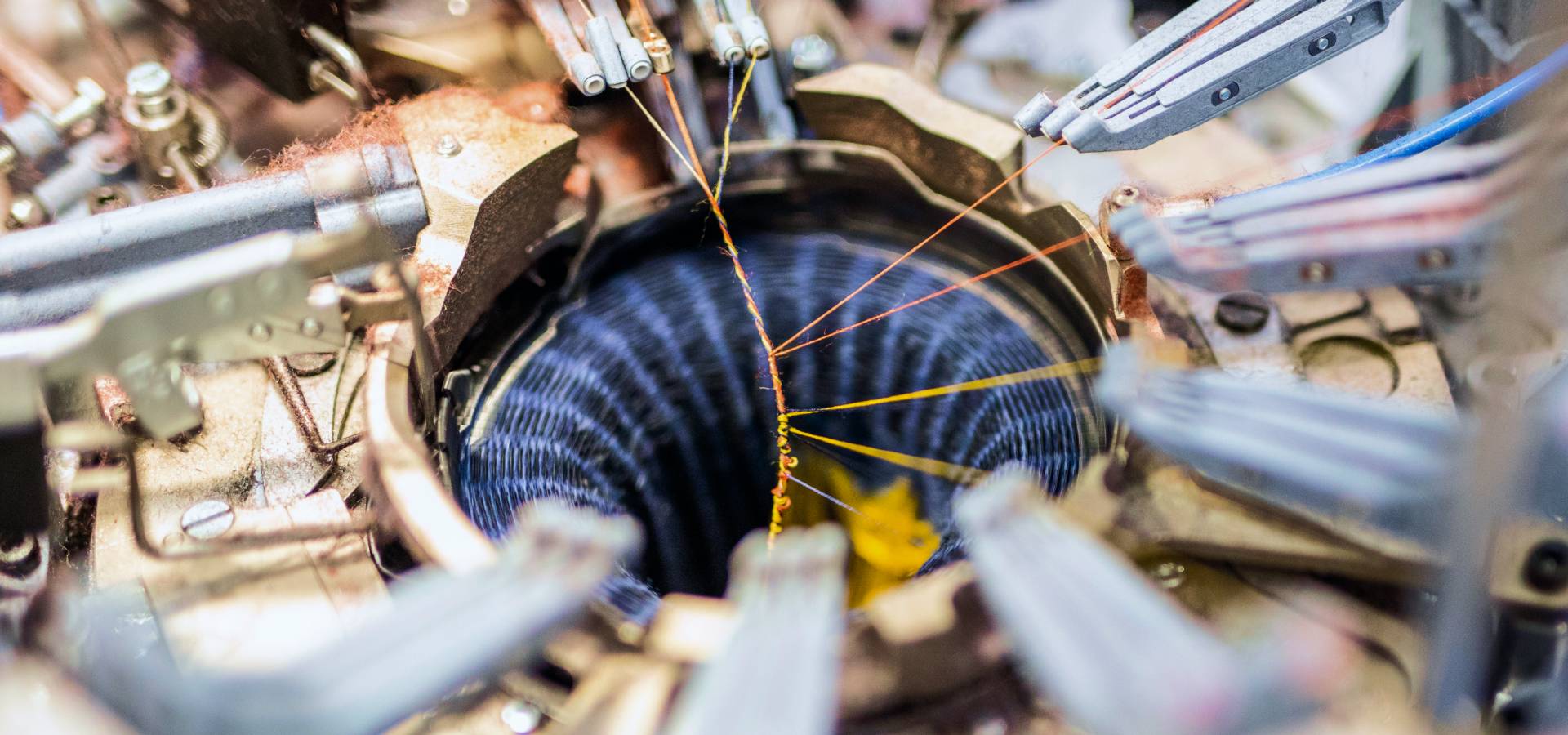 A close up look at merino wool yarn being turned into a sock on our knitting machines