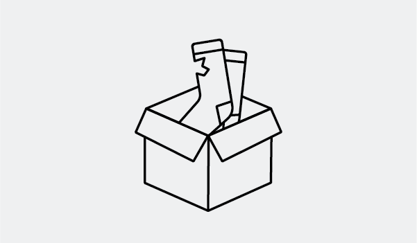 Worn socks being placed in shipping box