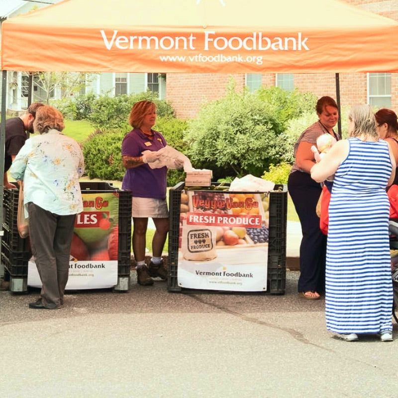 Booths of the Vermont Foodbank setup in the community, giving out food to those in need