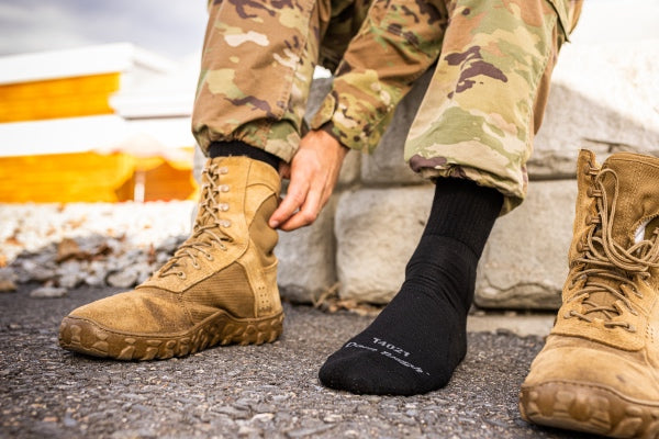 Pair of feet wearing the midweight T4021 socks with camo