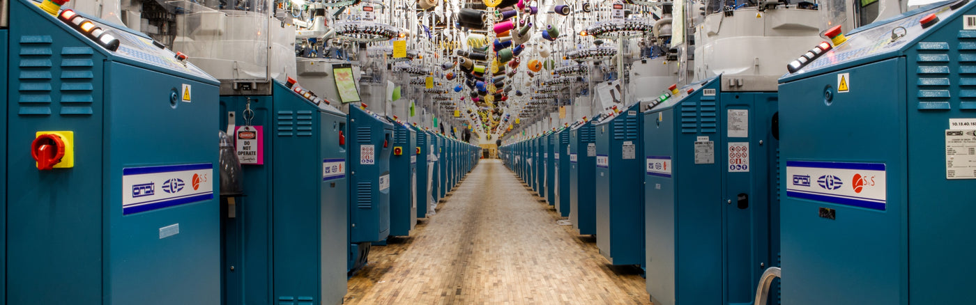An aisle of knitting machines at the Darn Tough mill, where we knit the world's best socks