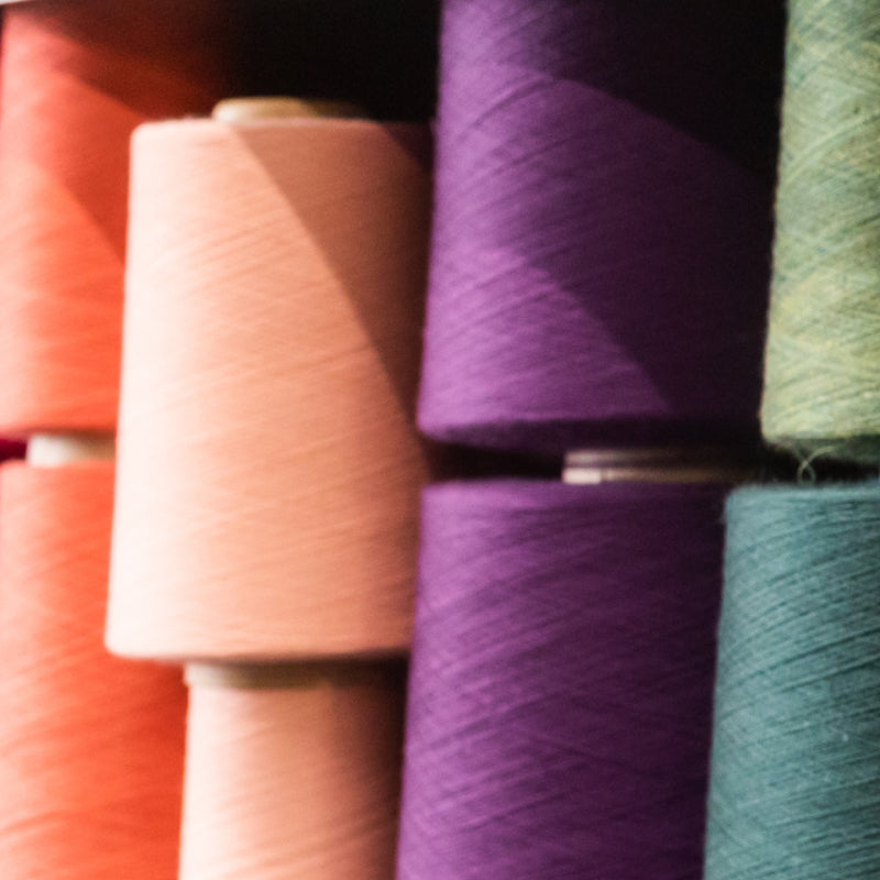 A row of brightly colored Merino Wool yarns used to knit socks