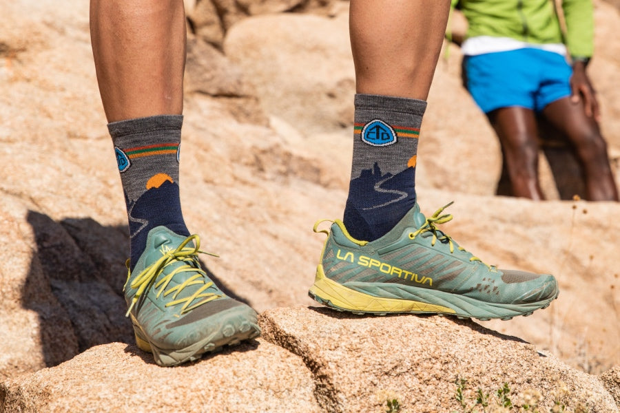 Pair of feet in hiking shoes and the CTD socks