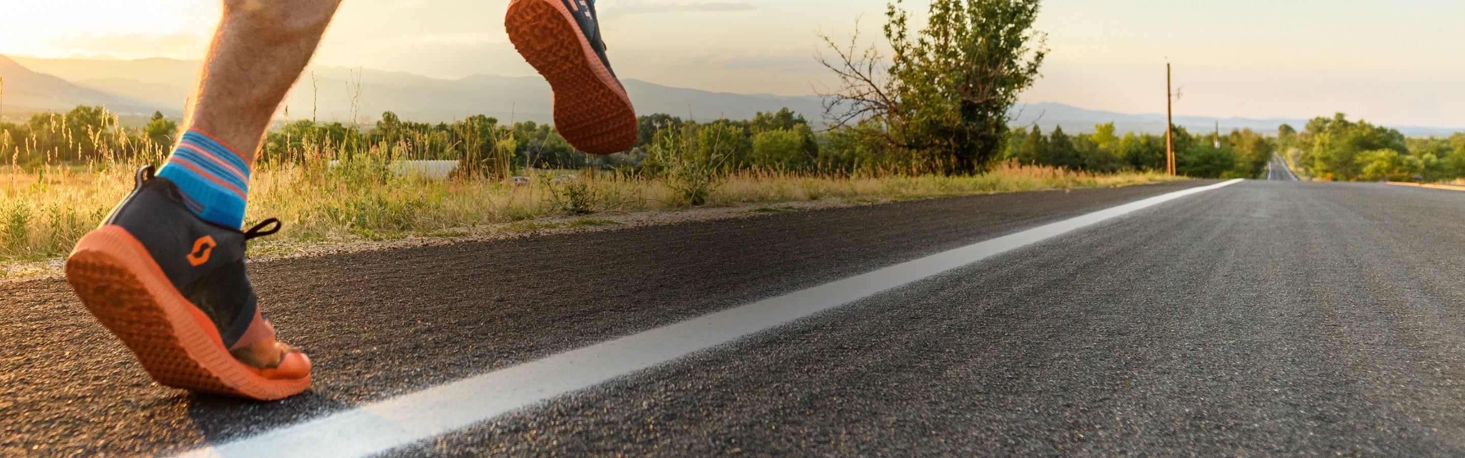 A runner headed down the road in a pair of Vertext Running Quarter Socks