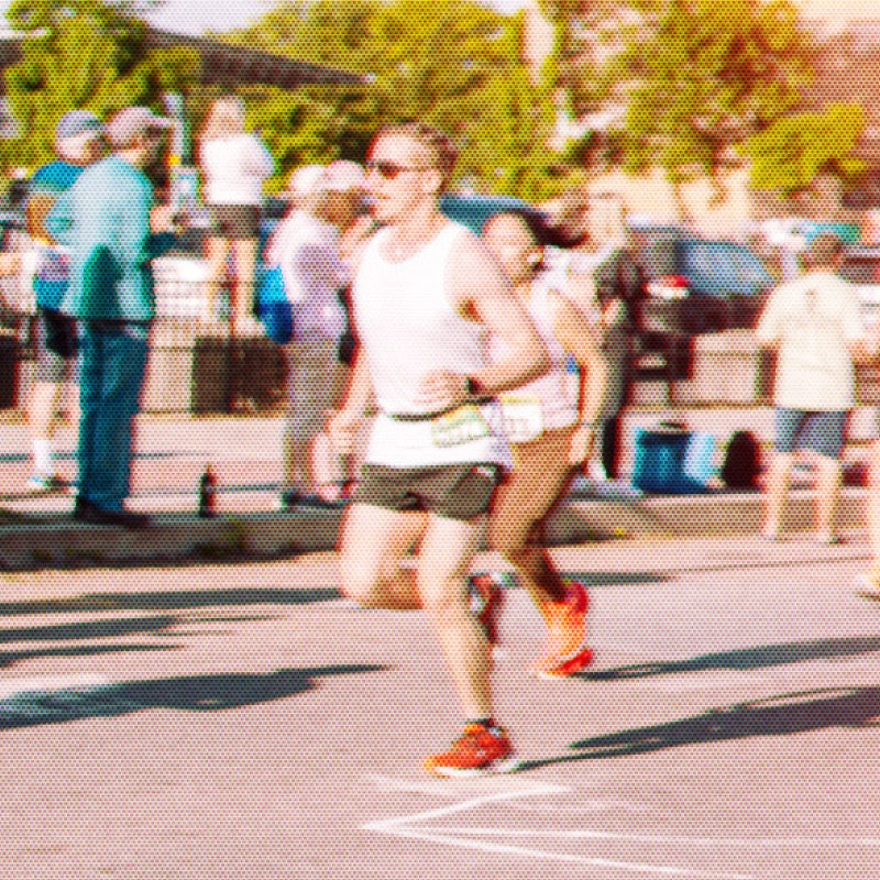 A runner at the start of a marathon wearing the original Darn Tough socks