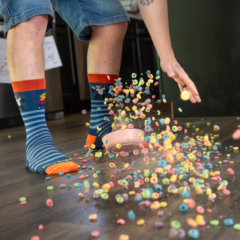 Low angle shot of a dad's feet surrounded by spilled milk and fruit loops from a toddler bowl