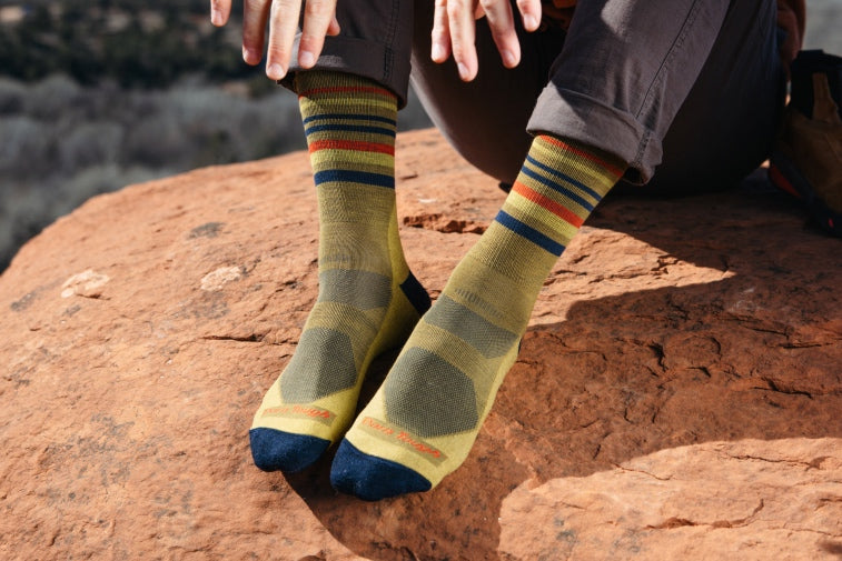 Shop Men's Hike - Feet wearing a pair of men's hiking socks with striped cuffs