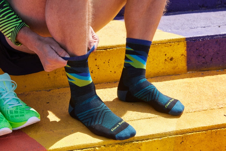 Shop Men's Running Socks - Feet wearing blue running socks from Darn Tough