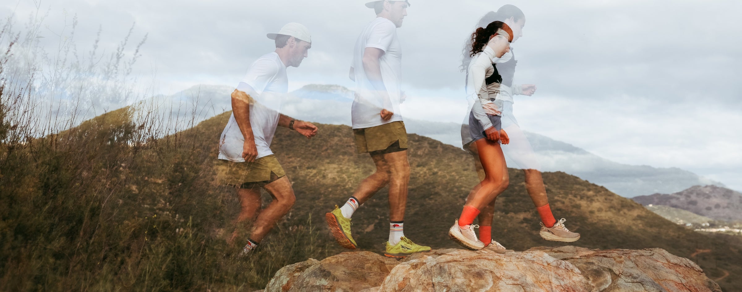 Two runners headed across a rocky trail- the image shows their motion