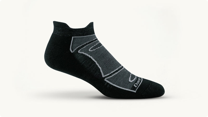 A black no show tab running sock with white vents on the top of the foot