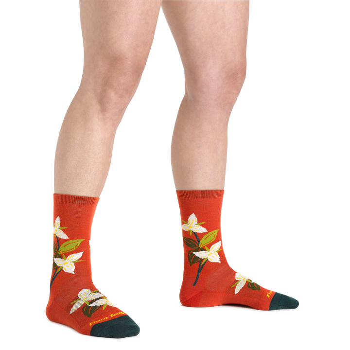 Model wearing Tomato Blossom Crew Lightweight Lifestyle  Socks with white and green flowers scattered