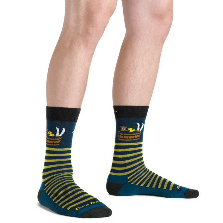 Model wearing one chelsea boot and Men's Wild Life Crew  Lifestyle Sock with yellow stripes and a bathing bear