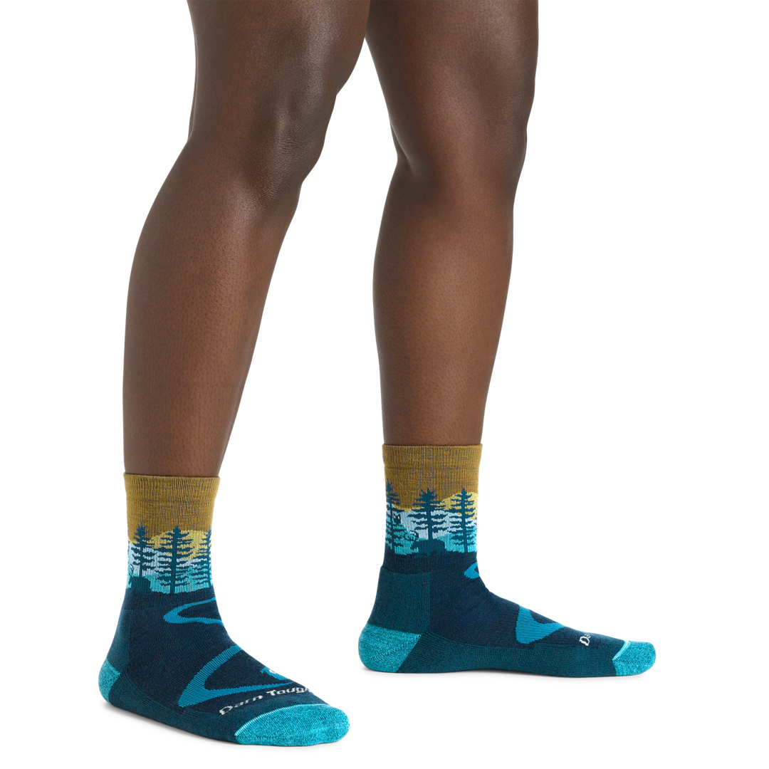Image of a woman's legs, , wearing Women's Northwoods Micro Crew Midweight Hiking Socks in Dark Teal with the moose showing