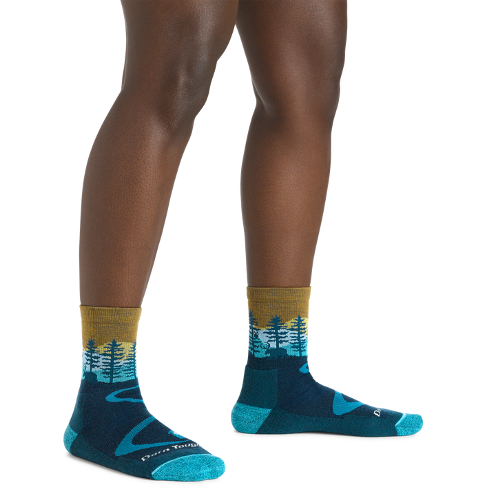Image of a woman's legs, , wearing Women's Northwoods Micro Crew Midweight Hiking Socks in Dark Teal with the moose showing
