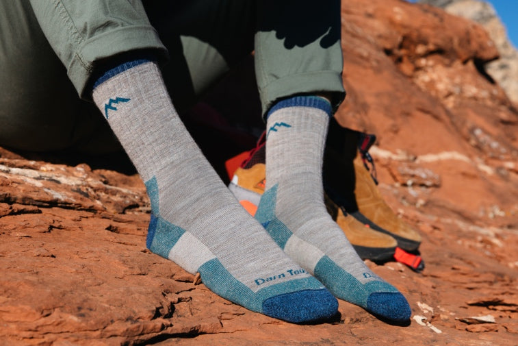 Shop Hiking Socks - feet wearing gray and blue hiking socks, the perfect gift for hikers