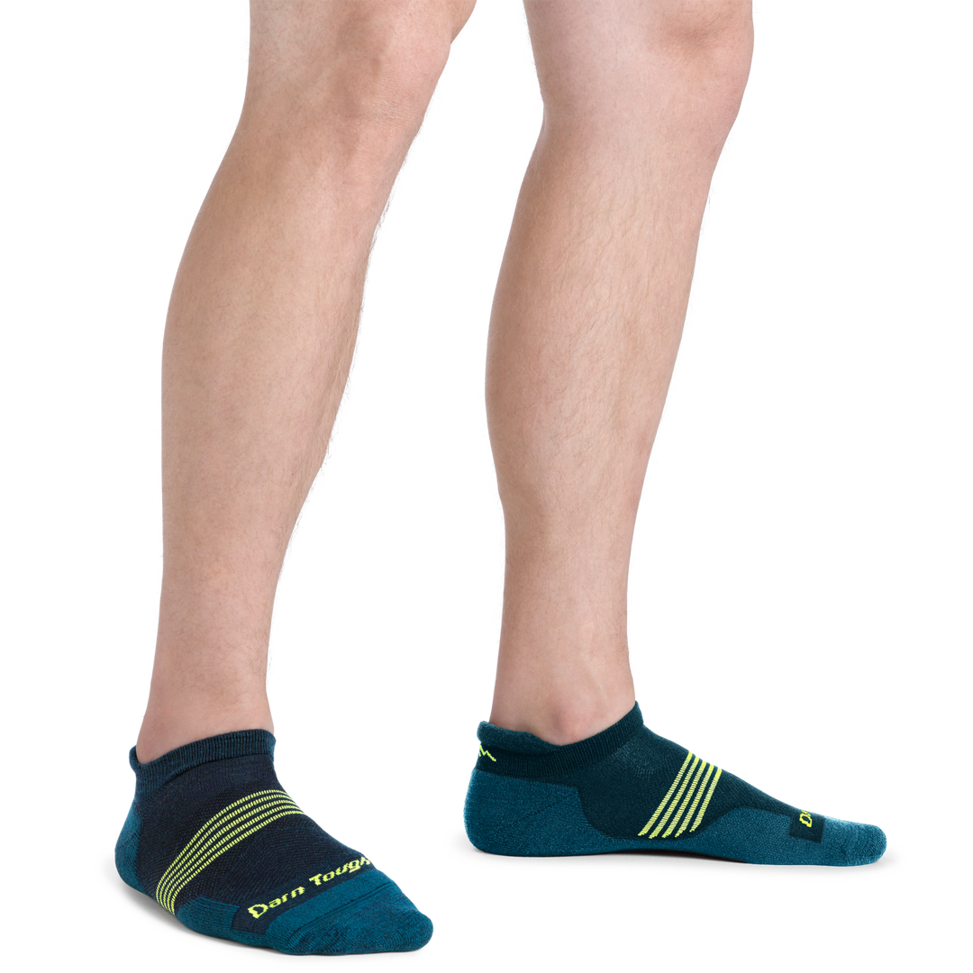Man standing wearing Element No Show Tab Lightweight Running Sock in Blue with lime Green stripes on the forefoot