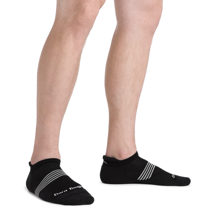 Man standing wearing Men's Element No Show Tab Lightweight Running Sock in black with white stripes