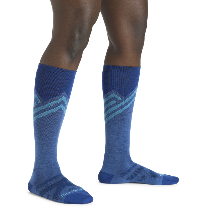 Model wearing Women's Peaks Over-the-Calf Ultra-Ligtweight Ski and Snowbaord socks in stellar blue