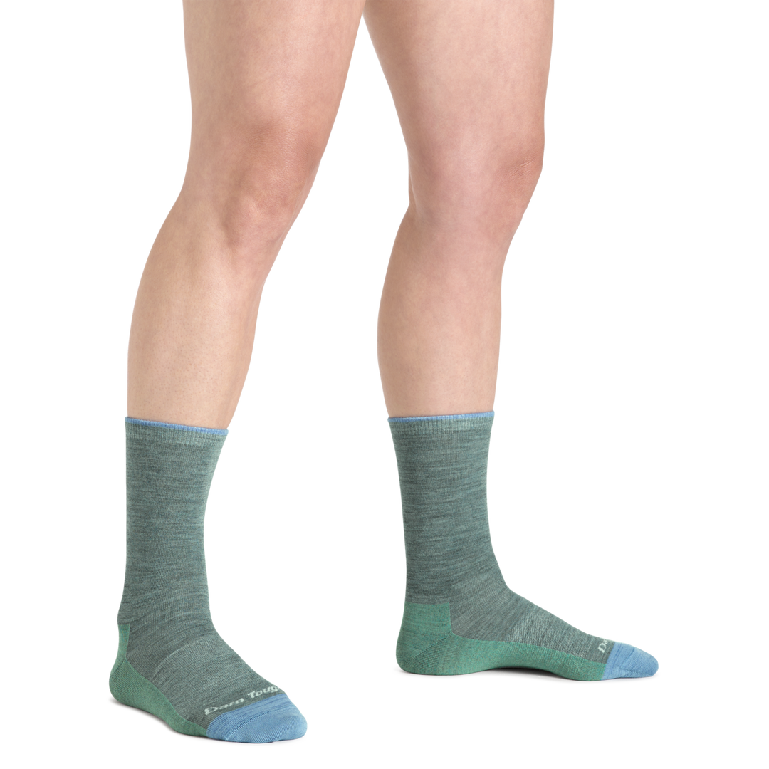 Model wearing Women's solid Basic Crew Lightweight Lifestyle sock in Seafoam with blue accents