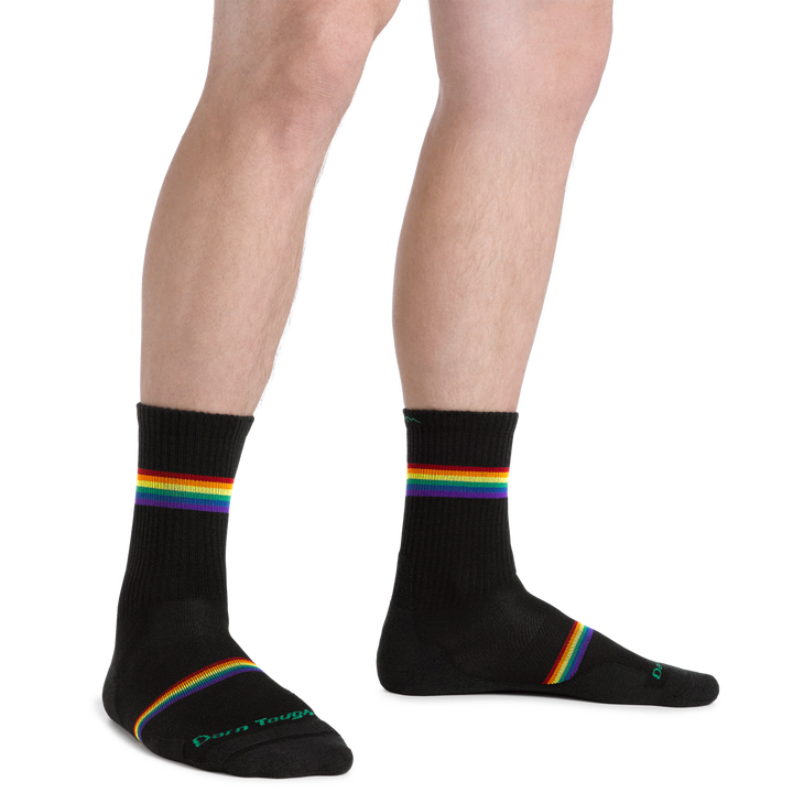 Man standing wearing Men's Prism Micro Crew Lightweight Running Sock with rainbow stripes above the ankle and forefoot