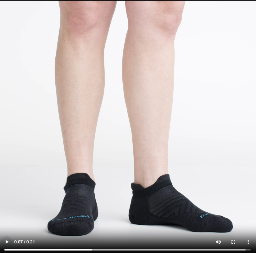 Video of model wearing cushion running no-show socks in black, rotating around to show the fit of the socks.