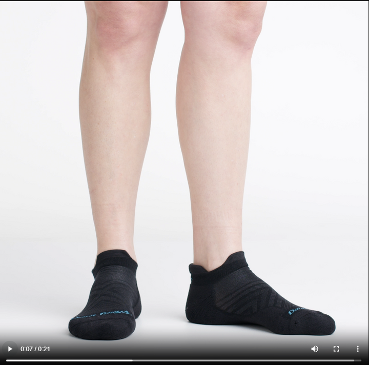 Video of model wearing cushion running no-show socks in black, rotating around to show the fit of the socks.