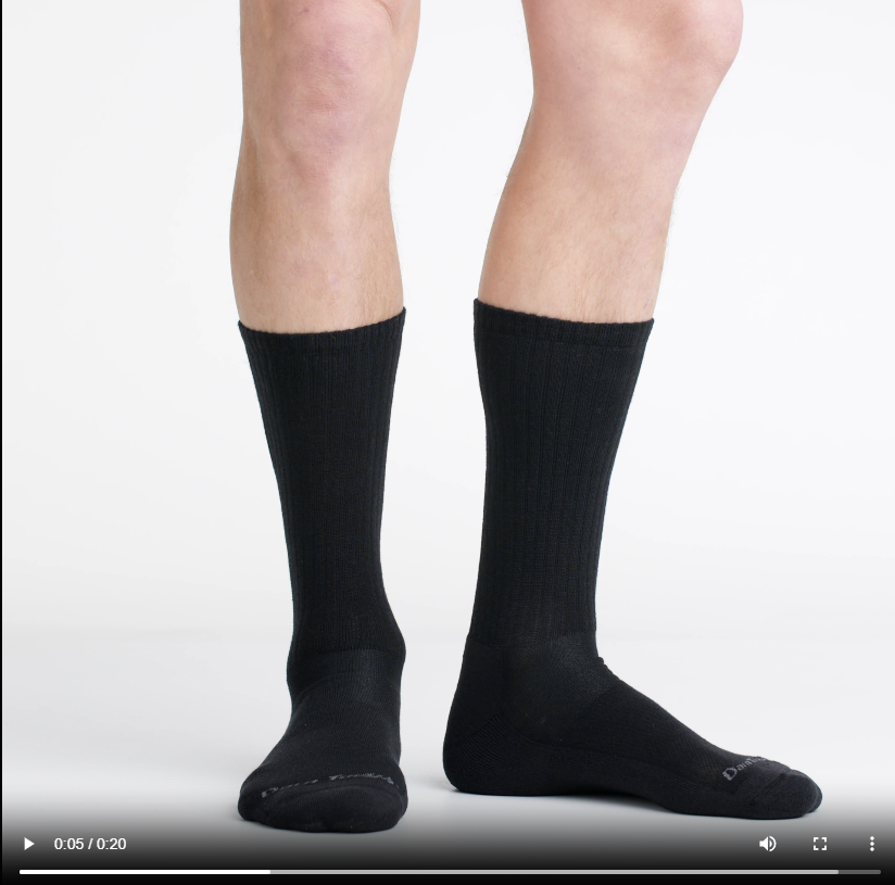 Video of model wearing standard crew socks in black, showing a 360 degree view of the socks.