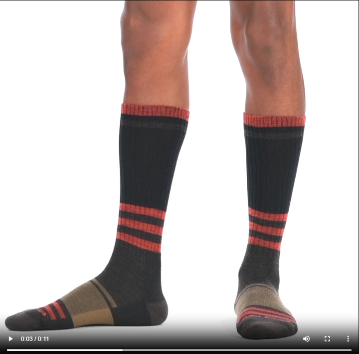 Video of model wearing Spur boot socks in hickory, rotating around to show the fit of the socks.