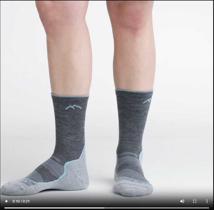 Video of model wearing light hiker micro crew socks in slate, rotating around to show the fit of the socks.