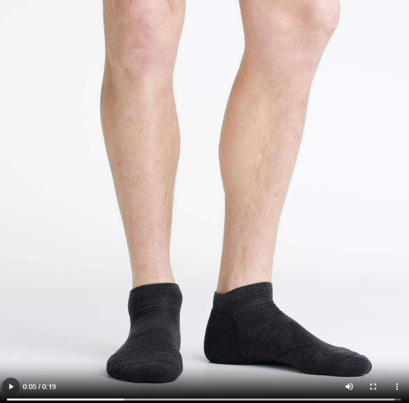 Video of model wearing light hiker no show socks in black, showing a 360 degree view of the socks.