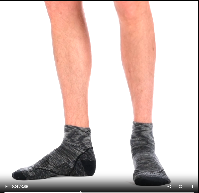 Video of model wearing Light hiker Quarter socks in space gray, rotating around to show the fit of the socks.