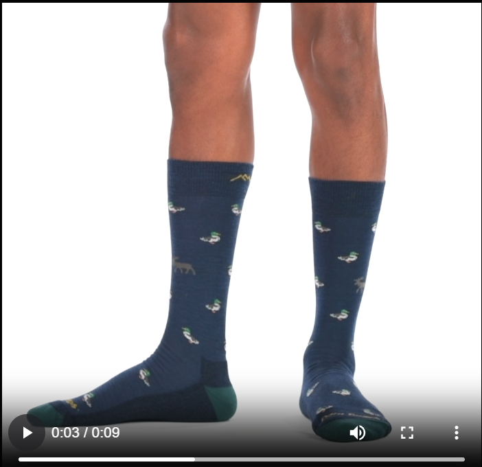 Video of model wearing duck duck moose crew socks, walking around to show all angles of the socks.