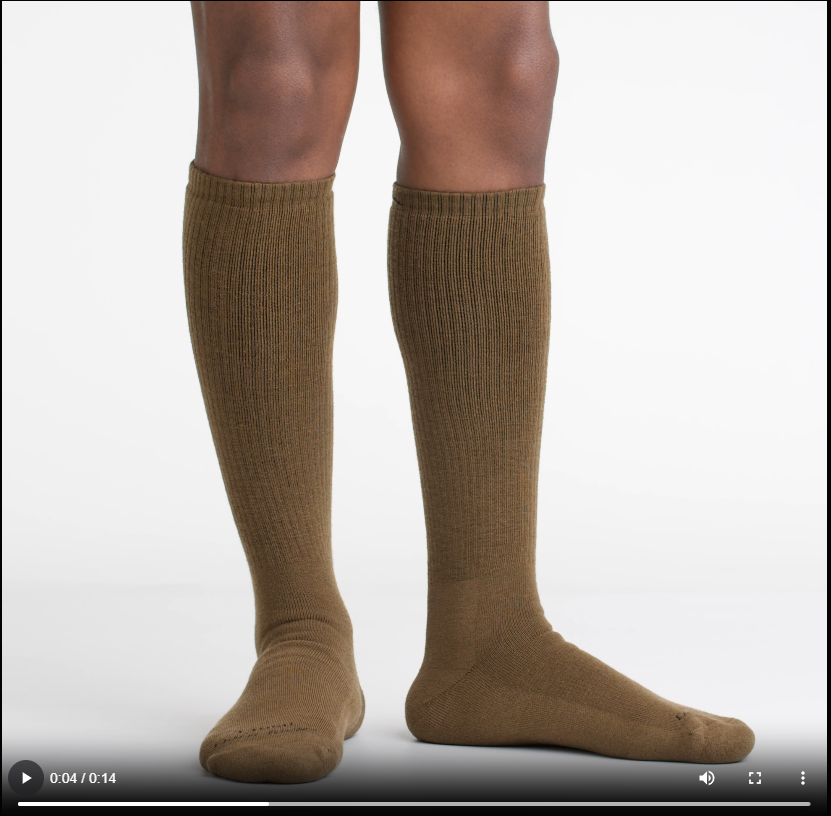 Person wearing T4050 socks walking on screen, turning around, and walking off to show fit
