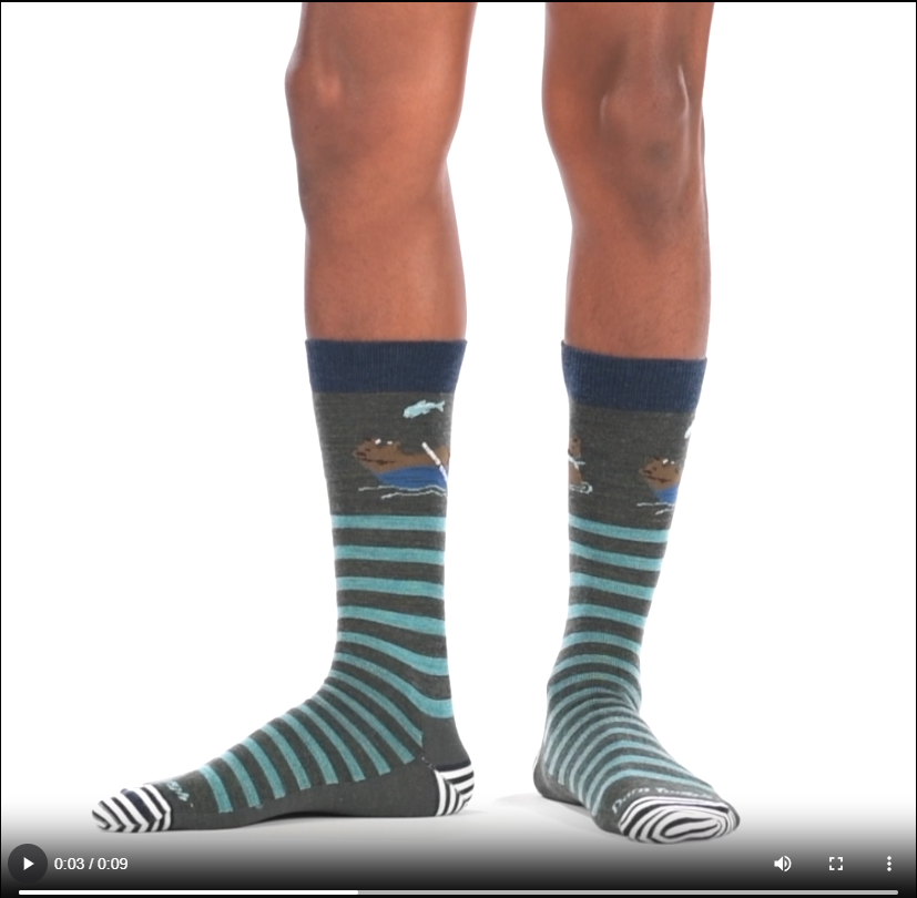 Video of model wearing Animal haus lifestyle crew socks in forest, rotating around to show the fit of the socks.