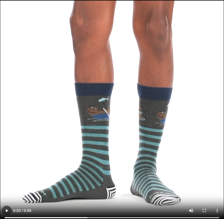 Video of model wearing Animal haus lifestyle crew socks in forest, rotating around to show the fit of the socks.