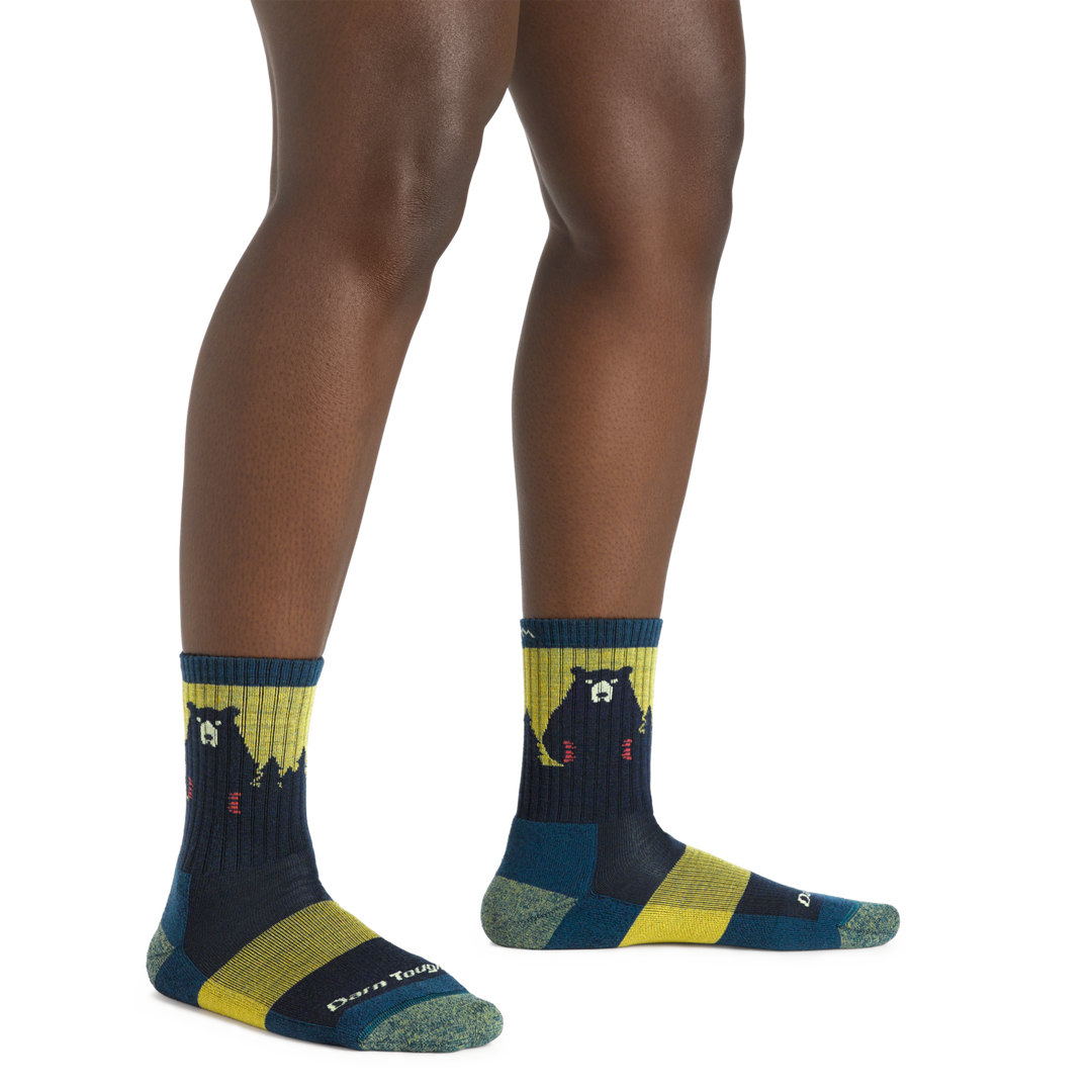 Model wearing the Women's Bear Town Micro Crew Hiking Sock in Dark Teal featuring a bear with red claws