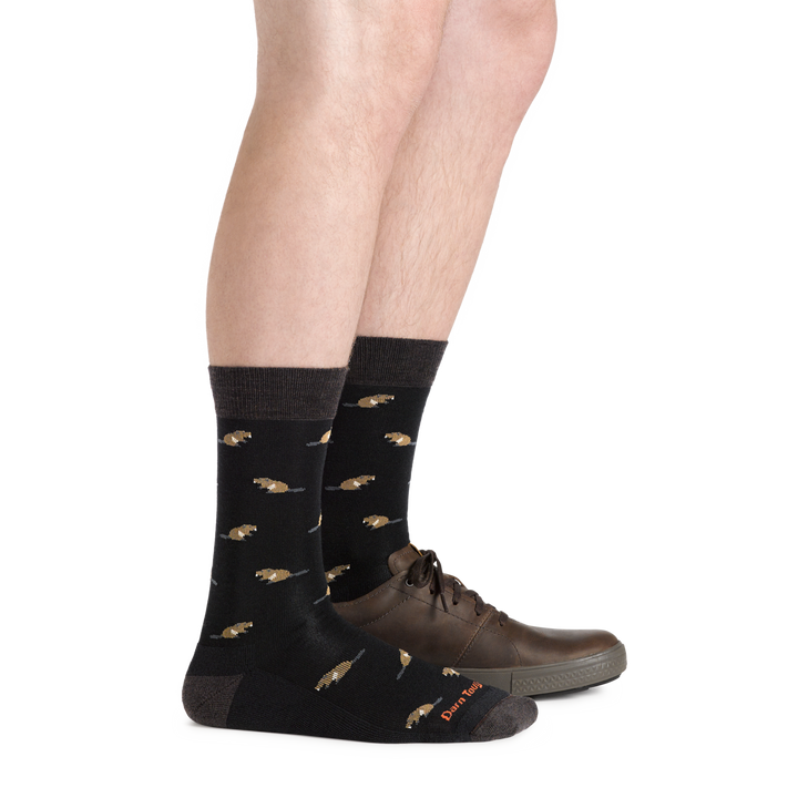Man wearing Men's Sawtooth crew Lightweight Lifestyle socks with a casual brown shoe on one foot