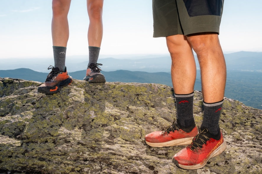 Two hikers wearing Hiker Micro Crew socks standing on a mountain summit