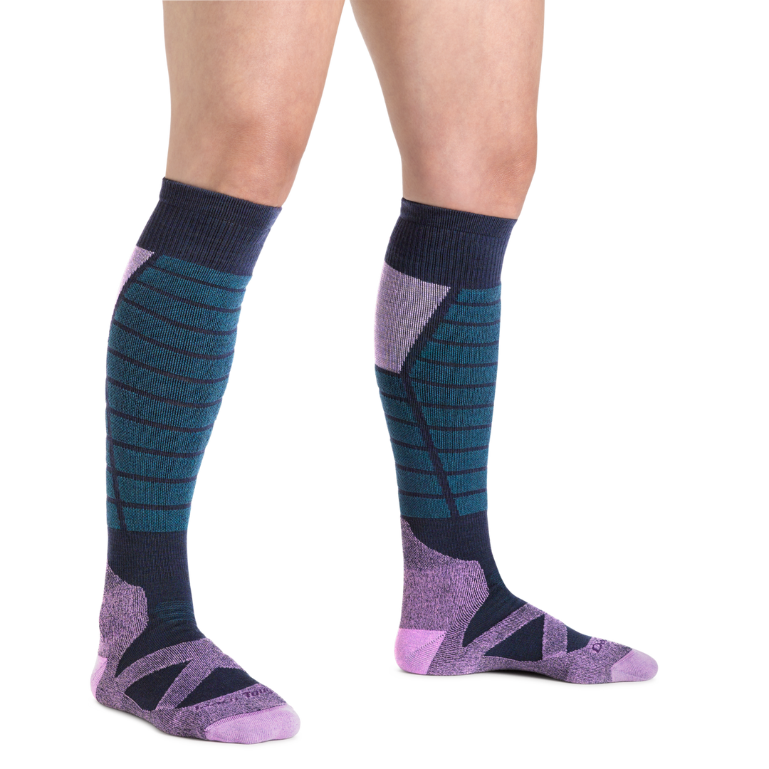 Woman wearing Women's Edge Over-the-Calf Ski and Snowboard sock in Purple and blue