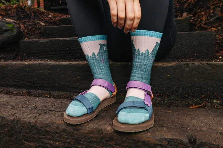 Shop gifts for her - feet wearing pink and blue darn tough women's socks