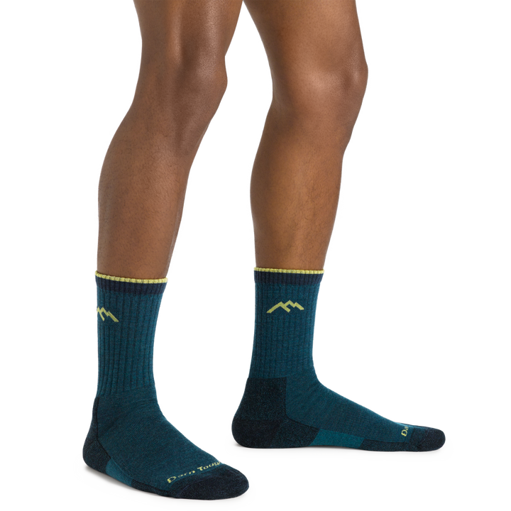 Model wearing the Men's Hiker Micro Crew Midweight Hiking Sock in Dark Teal with lime green accents