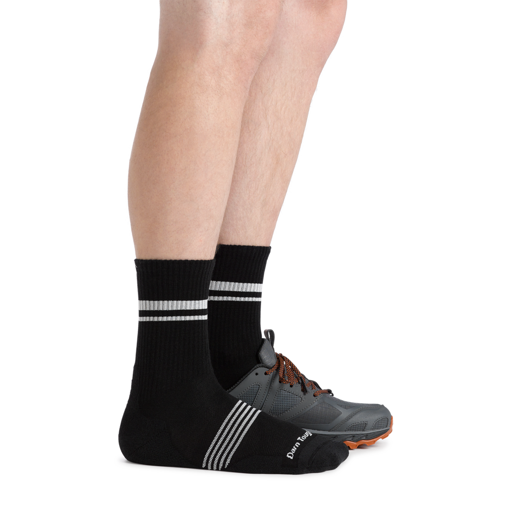 Man facing right wearing Men's Element Micro Crew Lightweight Running Sock in black and a hiking shoe on the left foot
