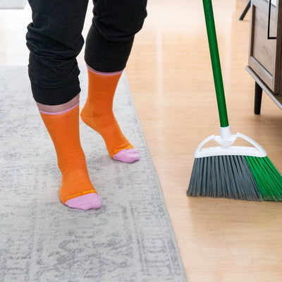 Shot of model sweeping the floor wearing the women&